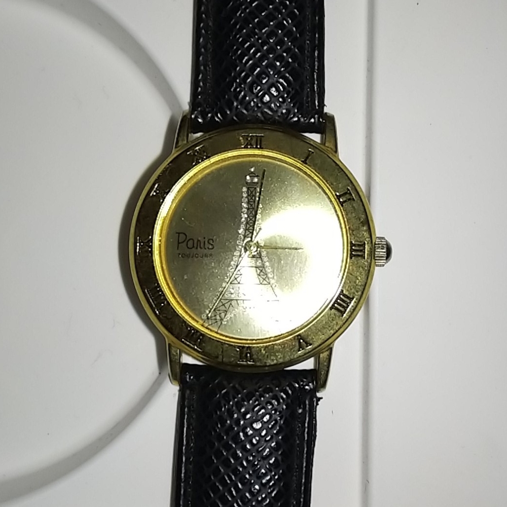 Wristwatch with Eiffel Tower etched in watch face.
